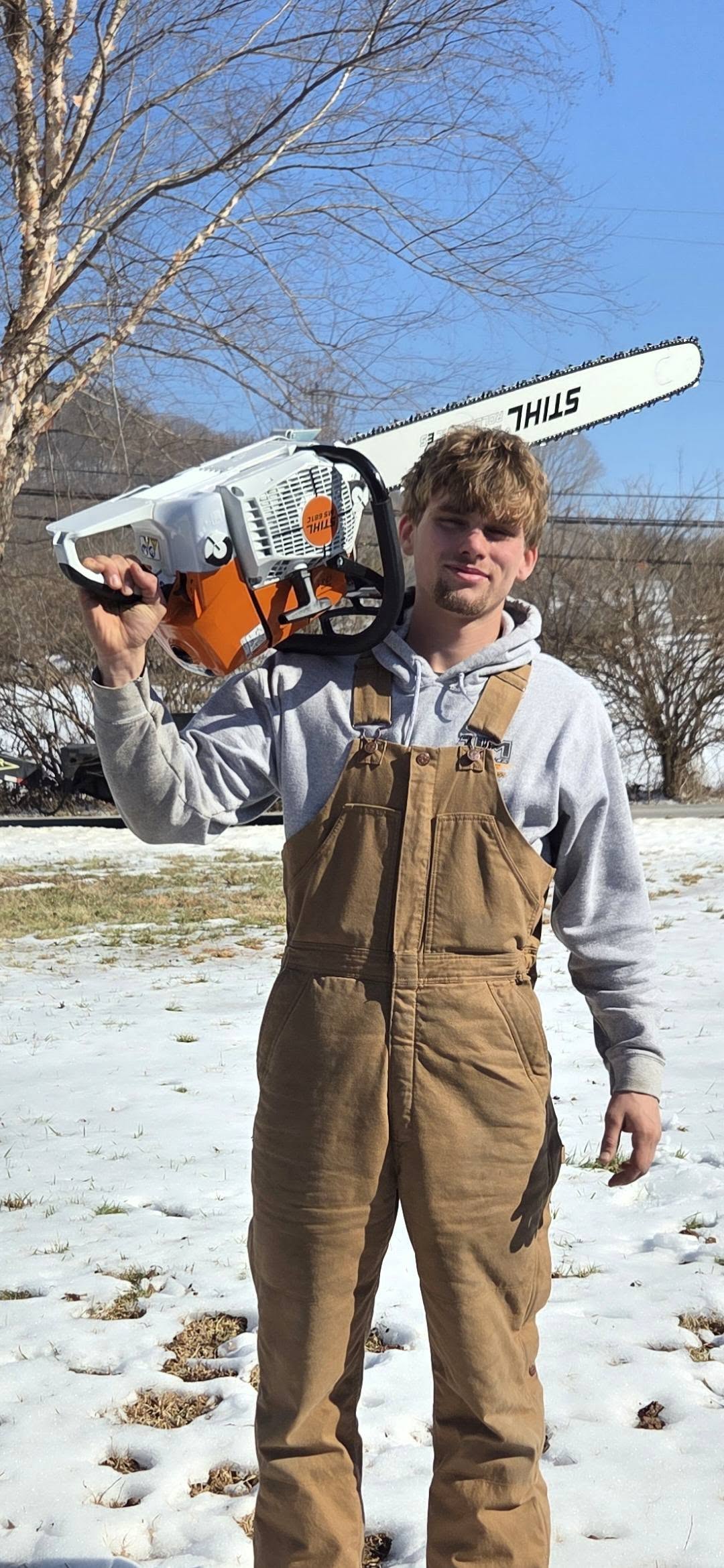 Justin with chainsaw in snow