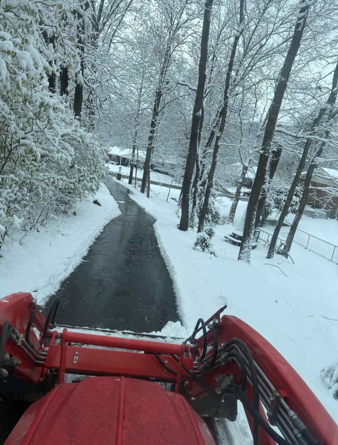 Snow plowing POV from tractor cab