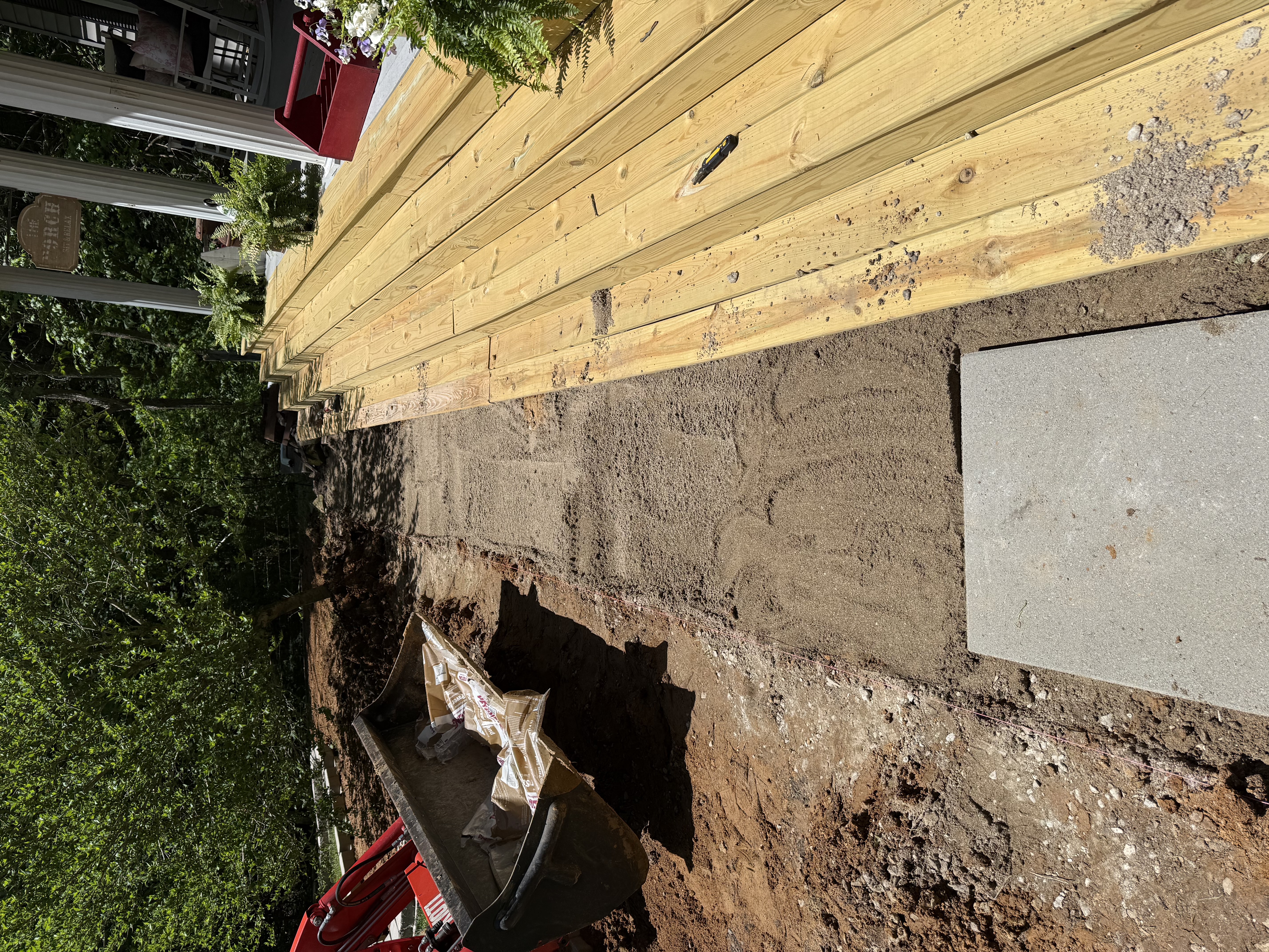 Retaining wall footing prep along new deck