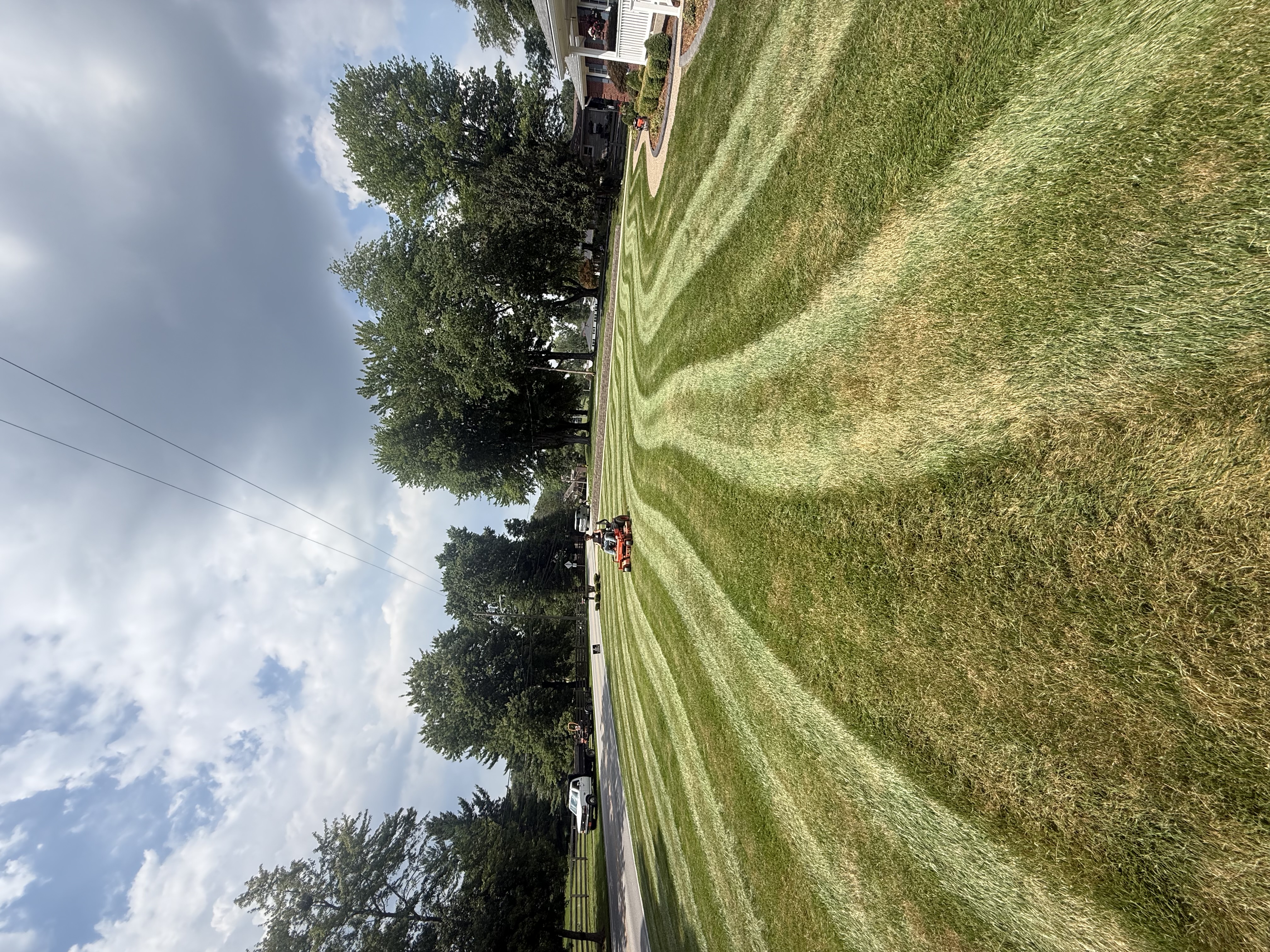 Zero-turn mower cutting fresh stripes into lawn