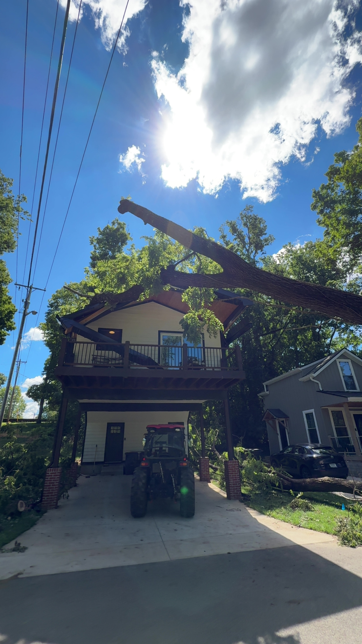 Large tree limb down on a roof after storm damage
